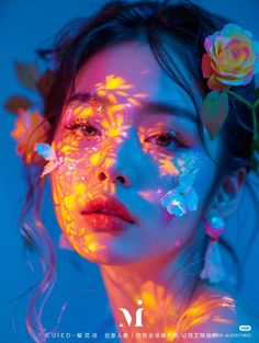 a woman with flowers in her hair and face is lit by neon light from the sun