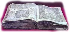 an open book sitting on top of a white table next to a pink light background