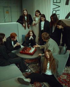 a group of young women sitting around a table