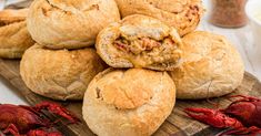 there are some breads that have been stuffed with meat and cheese on the table