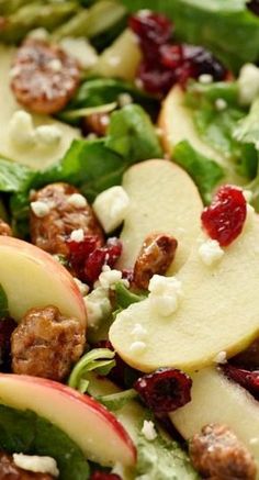 a salad with apples, cranberries and walnuts