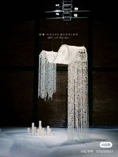 an artistic display with white icicles hanging from the ceiling