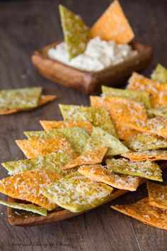 some tortilla chips are on a wooden table