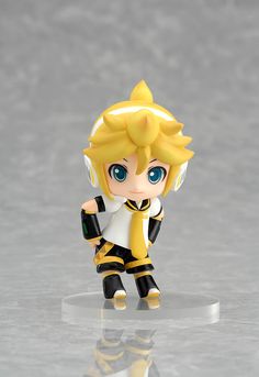 a figurine is standing on a reflective surface in front of a gray background