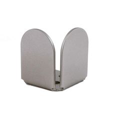 two metal bookends sitting next to each other on a white surface with one open and the other closed