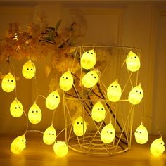 a bunch of lights that are sitting on a table next to a potted plant