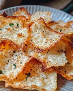 a white plate topped with cheesy crackers on top of a table