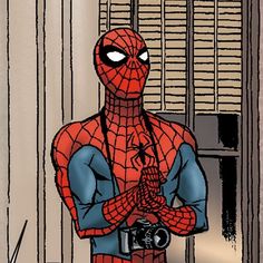 a spider - man standing in front of a window with his hands crossed and looking at the camera