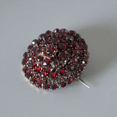 Stunningly beautiful antique red Bohemian garnet pin brooch. Authentic Victorian piece of jewelry from circa 1880's. Over 140 sparkling faceted red garnets are set in 4 consecutive tiers. The gold tone metal setting is a tombak alloy (also known as pinchbeck), which was very popular in the 19-th century. All photos were taken at daylight, the first 2 photos were taken at sunlight, so you can see how the the garnets are sparkling. The brooch will be shipped in a gift box. Garnet is known as the b Garnet Bracelet, Golden Ring, Garnet Necklace, January Birthstone, Garnet Stone, Victorian Jewelry, 14k Gold Ring, Red Garnet, 2 Photos