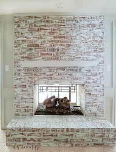 a brick fireplace with two stuffed animals on it's mantle in a living room