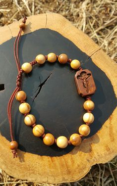 +. God Bless You. +. This is a Wooden Rosary Bracelet. +. It is knotted bracelet and it is adjustable . +. The crufix is carved in elevorate and three dementional shape. +. Beads are not round but beautifully angled. +.+.+.+.+. Materials +.+.+.+.+.+. Cross: Surinam Ebony Beads :olive tree +.+.+.+.+. Size +.+.+.+.+. Cross : 13.3mm(Width) *20mm(Height) Beads: 8mm +. Engraved characters(e.g. baptismal name, name,etc) on back side. It's Free engraving +. please send me characters that you want. +.Wo Spiritual Brown Rosary Bracelet For Gift, Catholic Rosary Bracelet, Knotted Rosary, Mens Rosary, Wooden Rosary, Rosary Jewelry, Knotted Bracelet, Bracelet Knots, Rosary Bracelet