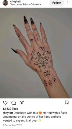 someone's hand with tattoos on it