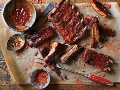 bbq ribs and barbecue sauce on a cutting board