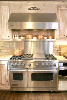 a stainless steel stove top oven sitting inside of a kitchen