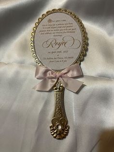 a wedding card with a pink bow on it's side and a gold frame