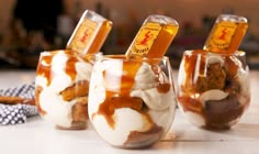 three glasses filled with desserts sitting on top of a white counter next to each other