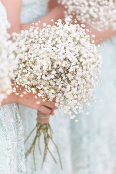 the bridesmaids are holding bouquets of baby's breath flowers in their hands