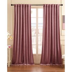 the curtains in this room are pink and have ruffled drapes on one side