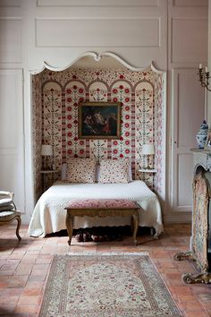 a bed sitting in the middle of a bedroom next to a painting