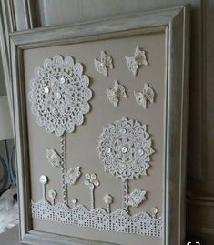 a white frame with some flowers and butterflies on it