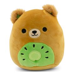 a brown teddy bear with a kiwi slice on it's face and eyes