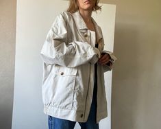 Vintage menswear bomber jacket with flap pockets. Zipper and button closure, lined. ✏️ TAGS WORLD HIT on buttons 65% cotton 35% polyamid lining 100% polyester ✂️ CONDITION  good vintage condition,  steamed and ready to wear. 📏 MEASUREMENTS  measured laying flat, please double for circumference: length 28" 71cm shoulders  23 1/4" 59cm bust 29" 74cm sleeve 24 1/2" 62cm  📌 PLEASE NOTE  If you're in doubt, please ask for more measurements or information. Although we try our best to reflect colors accurately, there might be slight differences in their appearance on your screen. Model is 5'6"/170cm tall with measurements 31-26-35 inches (79-66-89 cm) and wears size S All bemydear garments are pre-owned and may display minor signs of wear and age, but any notable flaws will be mentioned in desc Oversized Collared Outerwear With Side Pockets, Oversized Windbreaker With Pockets For Work, Collared Windbreaker With Pockets For Streetwear, Oversized Collared Outerwear With Multiple Pockets, Oversized Button-up Outerwear With Cargo Pockets, Oversized Cotton Windbreaker With Pockets, Vintage Oversized Outerwear With Pockets, Everyday Windbreaker With Pockets, Everyday Long Sleeve Windbreaker With Pockets