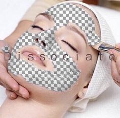 a woman is getting her face mask done with a checkered pattern on the side