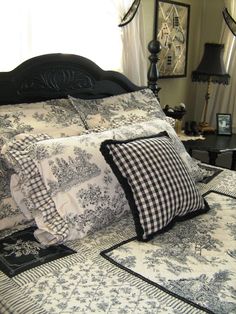 a black and white bed with pillows on it