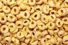 close up view of macaroni and cheese in the form of spirals or donuts