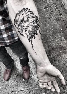 a man's arm with an eagle tattoo on it