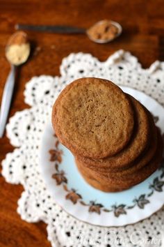 a stack of cookies sitting on top of a white plate next to a fork and spoon