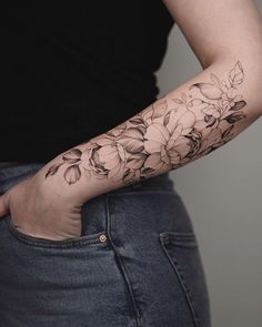 a woman with a flower tattoo on her arm