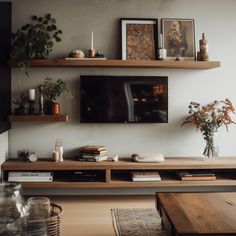 a flat screen tv sitting on top of a wooden shelf