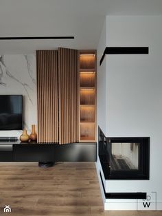 a modern living room with wood paneling and white walls, including a tv on the wall