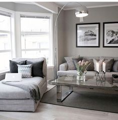 a living room with two couches and a coffee table in front of the window