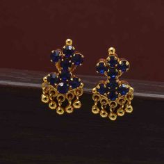 Cute Gold Plated Small Adial Stone Earrings intricately studded with synthetic stones in the form of triangle motifs pendant, with tassels of golden beads. These small studs are apt for youngsters and elder women with any outfit.