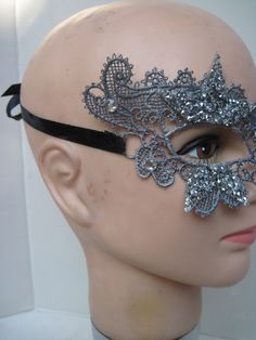 * This stiff silver lace half mask has been designed with five pointed silver beaded stars which have been trimmed and stationed around each eye. Down the front of the mask four faceted crystals accent the shape of the nose. * To secure the mask there are two black satin ribbons on each side to be tied in the back. * A great piece for a Masked Ball, a Night at the Opera, Class Reunion, Birthday Celebration, Halloween, New Year's Celebrations, Parade or Festival, Costume party or Play, Carnivale, Masquerade Half Mask, Beaded Stars, Night At The Opera, Festival Costume, Masked Ball, A Night At The Opera, Lace Mask, Half Mask, Class Reunion