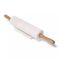 a white rolling pin with wooden handle on a white background