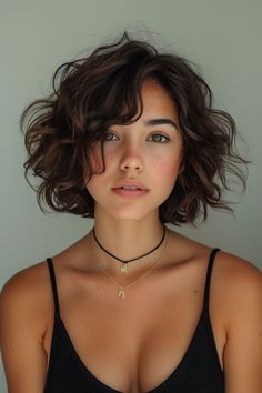 a woman with short hair wearing a black tank top and choker necklace on her neck