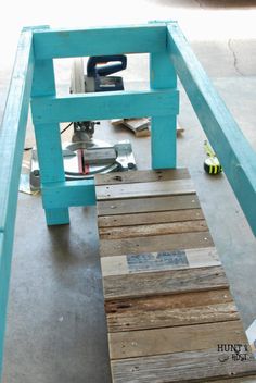 a table made out of pallet wood with a sawhorse on the top and some other tools around it