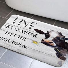 a bathroom rug with a cow painted on it's side and the words live like someone left the gate open