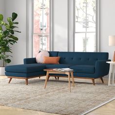 a living room scene with focus on the couch and coffee table in the foreground