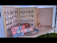 an open suitcase sitting on top of a table filled with lots of boxes and magnets