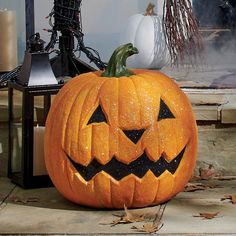 a carved pumpkin sitting on top of a porch