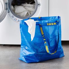 a blue bag sitting next to a washing machine