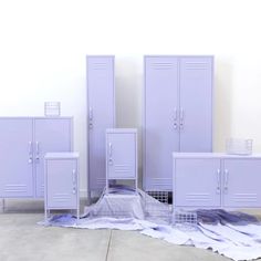 several purple lockers sitting next to each other on the ground in front of a white wall