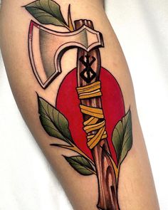 a tattoo on the leg of a person with a hammer and pasta wrapped around it