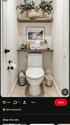 a white toilet sitting inside of a bathroom next to a wooden shelf filled with plants