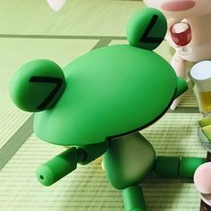 a cartoon character holding a beer glass next to another character on a table with food and drinks