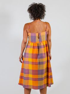 Every closet needs a strappy summer dress - its custom woven cotton in a perfect plaid is an added bonus! Dress this up for an event like a graduation or shower, or throw it on to run errands. You'll feel comfortable and cool either way! Fit Note: Runs large in bust. Those between sizes will want to size down 100% Cotton Keyhole button at back Hidden pockets Empire waist Adjustable straps Length of size S is 38" from top of bodice Made fair trade in Nepal by one of our longstanding production pa Closet Needs, Woven Cotton, Empire Waist, Cotton Weaving, Fair Trade, Nepal, Summer Dress, Ivy, Bodice